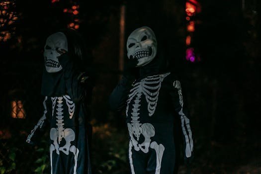 Two individuals wearing skeleton costumes at night, evoking a Halloween ambiance. halloween costumes
